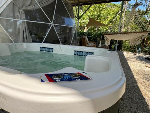 a jacuzzi tub with a flag on it at Amaj Eco Lodge in Sámara