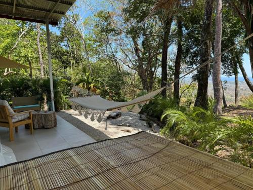 a hammock on the patio of a house at Amaj Eco Lodge in Sámara