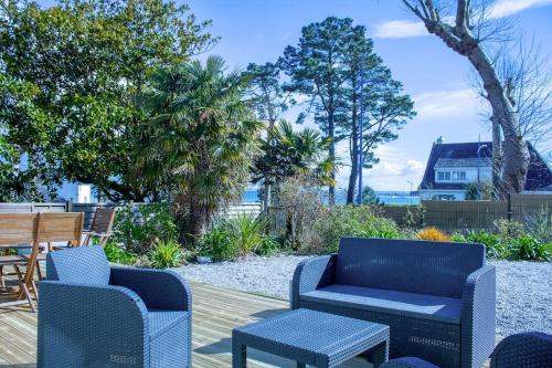 a patio with two chairs and a table and chairs at Ar Mervent/Plage à pieds in Crozon