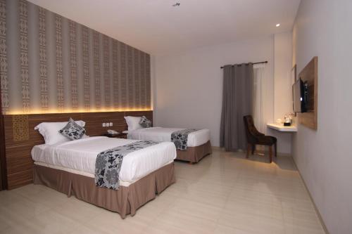 Ένα ή περισσότερα κρεβάτια σε δωμάτιο στο Grand Amira Hotel
