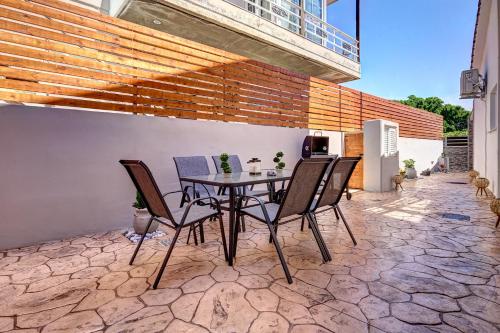 a table and chairs sitting on a patio at Sea & Joy House in Ialyssos