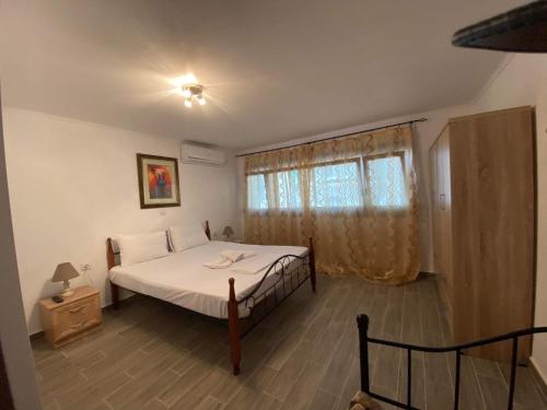 a bedroom with a bed and a window at Penelope's apartment Ι in Potamiá