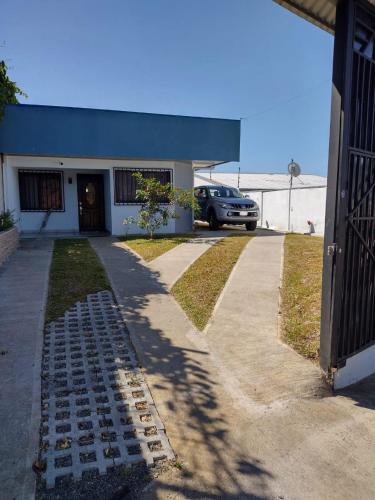 a car parked in front of a building with a driveway at Burios House in Alajuela City