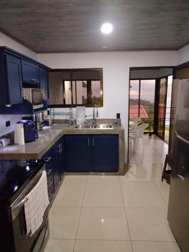 a kitchen with a sink and a counter top at Burios House in Alajuela City