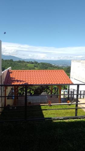 an orange roof on a gazebo with a view at Burios House in Alajuela