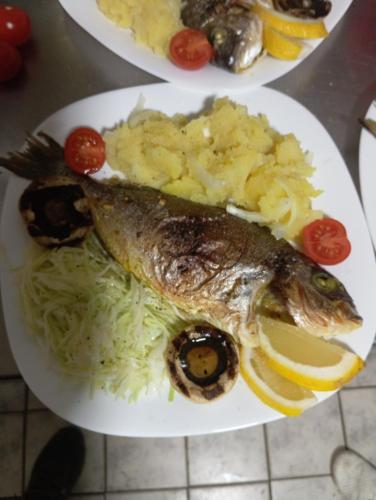 a plate of food with a fish and mashed potatoes at Marko Konak in Niš