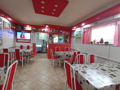 a restaurant with tables and chairs and a tv at Marko Konak in Niš