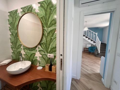 a bathroom with a sink and a mirror on a wall at Villa Costanza sorrento B&b in Sant'Agnello
