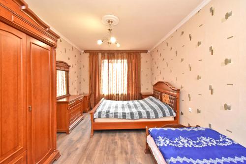 a bedroom with a bed and wooden furniture in a room at Apartment in Zakyan 4 street in Yerevan