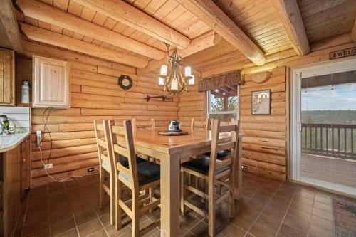 a wooden dining room with a wooden table and chairs at 5 Acres! Modern Cabin w/ Pikes Peak View in Florissant