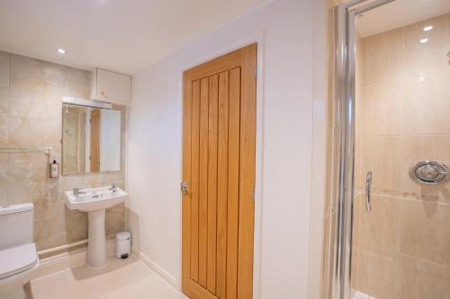 La salle de bains est pourvue d'une douche, de toilettes et d'un lavabo. dans l'établissement The Pheasant Inn, à Falstone
