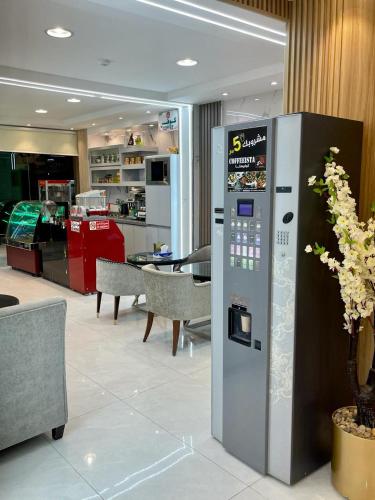 a vending machine in a room with a restaurant at Bahget Eljouf Furnished Apartment in Sakakah
