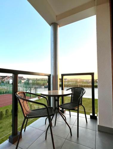 a patio with a table and chairs on a balcony at Piękny Apartament Blisko Morza - Sarbinowo in Sarbinowo