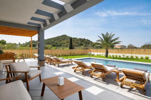 a patio with chairs and a swimming pool at Ixian Memory in Triánta