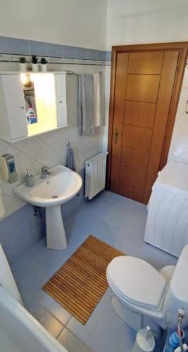 a bathroom with a toilet and a sink at Sunrise Metamorfosi in Metamorfosi