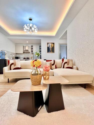 a living room with a couch and a table at Melodious homes elite residency in Nairobi