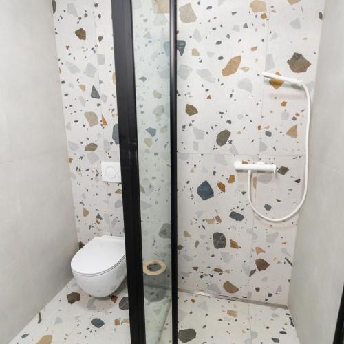 a bathroom with a toilet and a shower at Bubbly Apartment in Bled