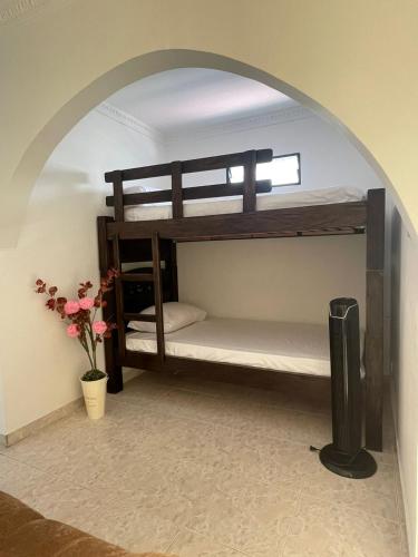 two bunk beds in a room with a window at Apartamento para máx 5 personas, habitación privada con cama doble , habitación abierta con camarote y sofá cama, comodo, bonito, central, bien ubicado, en el centro de palmira in Palmira