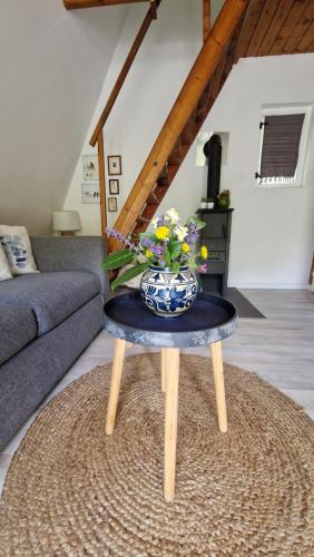 a blue and white vase on a table in a living room at Albatross in Dömös