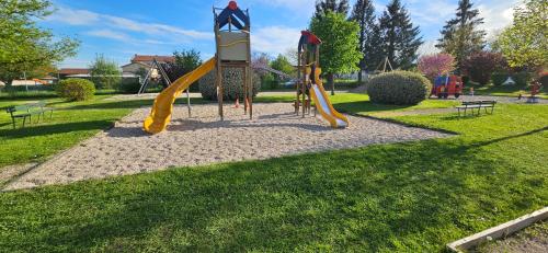 a playground in a park with yellow slides at appartement guy in Priay