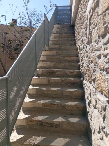 a set of stairs with a metal railing at Villa katina in Pitsidia