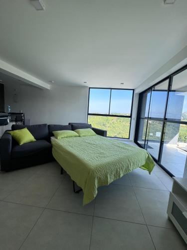 a bedroom with a bed and a couch at Luxurious With Private Jacuzzi 3-Bedroom Apartment in Pereira in San Joaquín