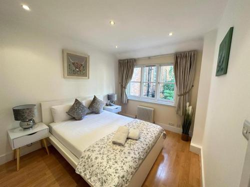 a bedroom with a bed with two towels on it at Comfortable Family Villa in London