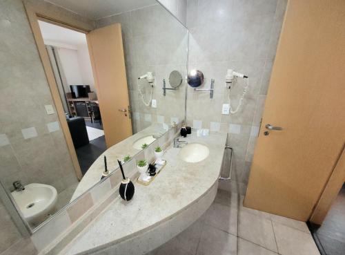 a bathroom with a sink and a mirror at Maximus Luxury in Berrini - Flat at the Radisson Hotel in São Paulo