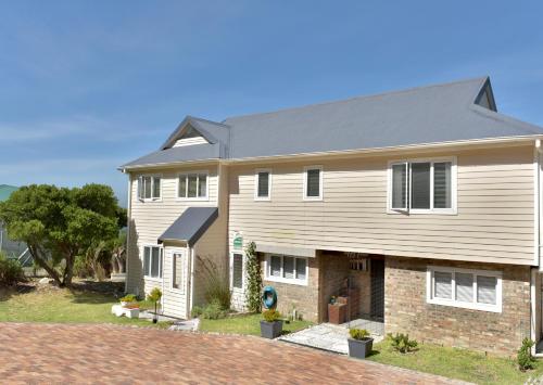 a large house with a gray roof at Seaview on 2822 Happy Whale Cottage in Bettyʼs Bay