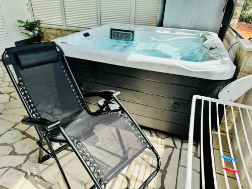 a chair sitting in front of a hot tub at Villa Sirenis in Trogir