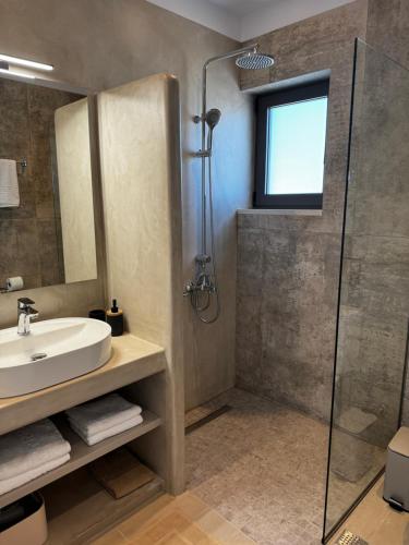 a bathroom with a sink and a shower at Villa Elaia in Sitia