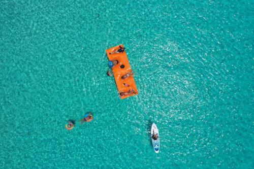 an overhead view of a pier in the water with a boat at Paradise Cove home in Gregory Town