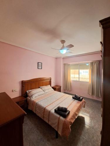 a bedroom with a bed and a ceiling fan at Gabriella Apartment Near the beach in Puerto de Sagunto