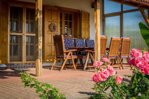 a group of chairs and a table on a porch at BorászPorta in Villány