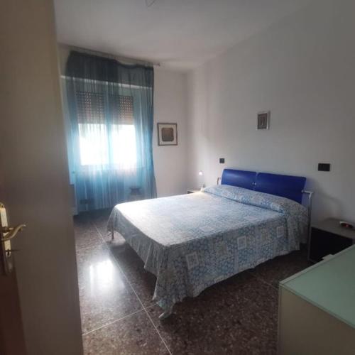a bedroom with a blue bed and a window at IL paradiso di Ani in Albisola Superiore
