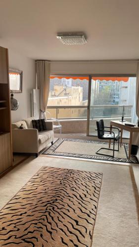 a living room with a zebra rug on the floor at Un studio de luxe Les Champs Elysées in Paris