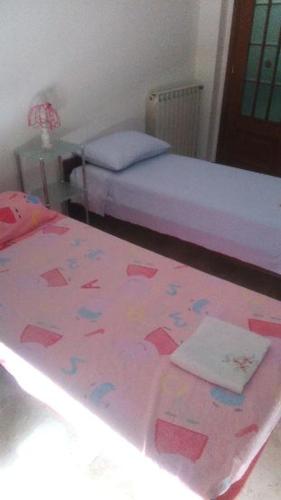 a bedroom with two beds with hearts on the floor at IL paradiso di Ani in Albisola Superiore