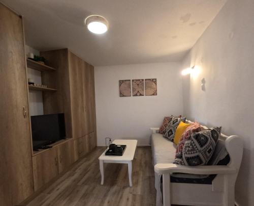 a small living room with a couch and a table at Stone House in Sitia