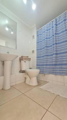uma casa de banho com um lavatório, um WC e um espelho. em Amplio y Acogedor Departamento . em Los Ángeles