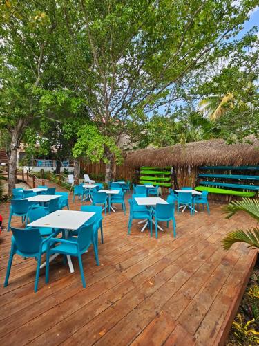 a bunch of tables and chairs on a wooden deck at Estancia del Agua Luxury View in Xul-Ha