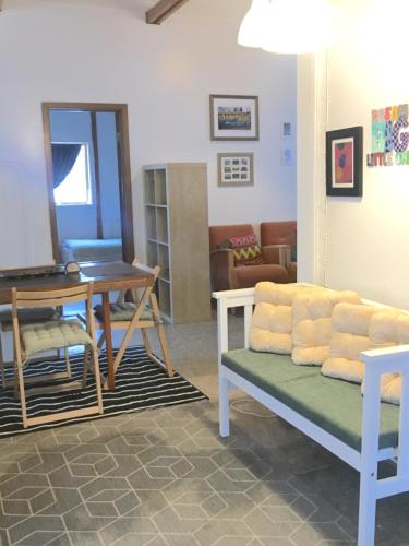 a living room with a couch and a table at The house next to the hot spring in Selfoss