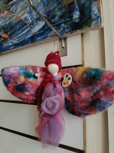 a stuffed teddy bear hanging on a wall at El Secreto Casa Art in Montevideo