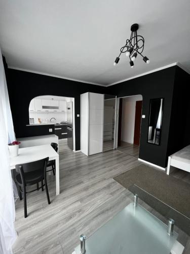 sala de estar con mesa blanca y cocina en 4 kąty na granicy z Sopotem en Gdansk