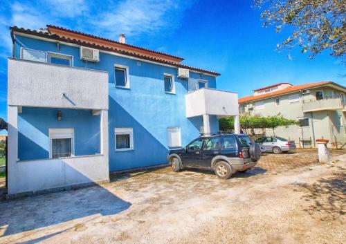 een blauw huis met een auto ervoor geparkeerd bij Ferienwohnung für 2 Personen ca 24 qm in Fažana, Istrien Istrische Riviera - b60963 in Fažana