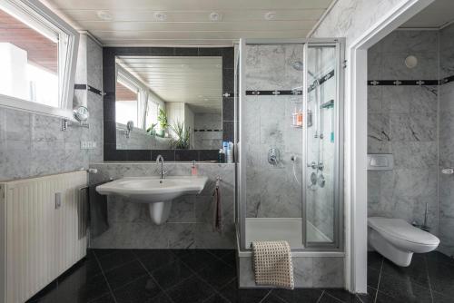 a bathroom with a sink and a shower at Munich Rooftop Retreat in Munich