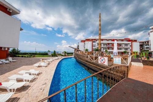 een boot naast een zwembad naast een gebouw bij Привилидж первая линия in Sveti Vlas