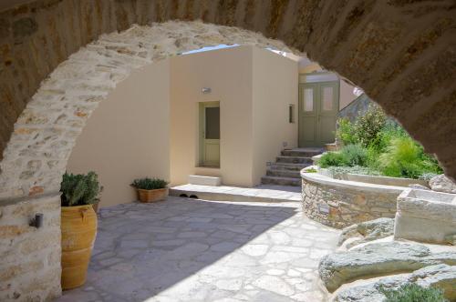 an archway of a building with some plants at Floris Manor in Ermoupoli