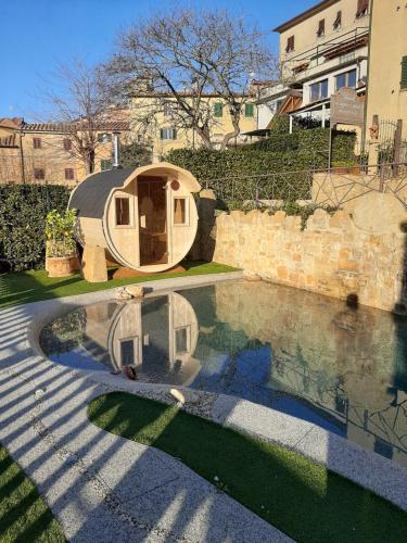 a tent is sitting next to a swimming pool at B&B Il Sogno del Pinzagrilli in Guardistallo