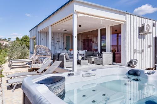 a hot tub on the patio of a house at Ferienhaus mit Privatpool für 4 Personen ca 54 qm in Drage, Dalmatien Norddalmatien in Drage