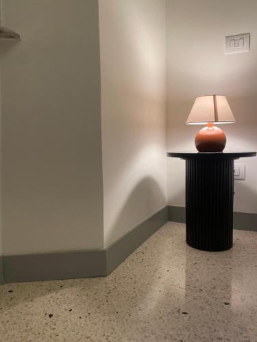 a lamp sitting on a table in a room at Veneto Suite 2 by SupaStays - King room in Rome